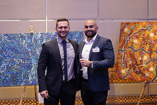 Les Delaforce and man in front of Aboriginal artwork at WTA2019